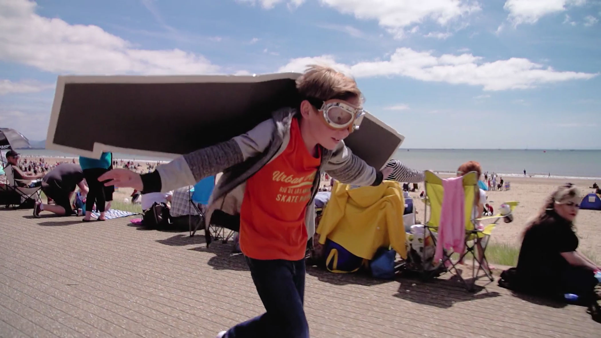 Boy pretending to be aeroplane at Wales Airshow