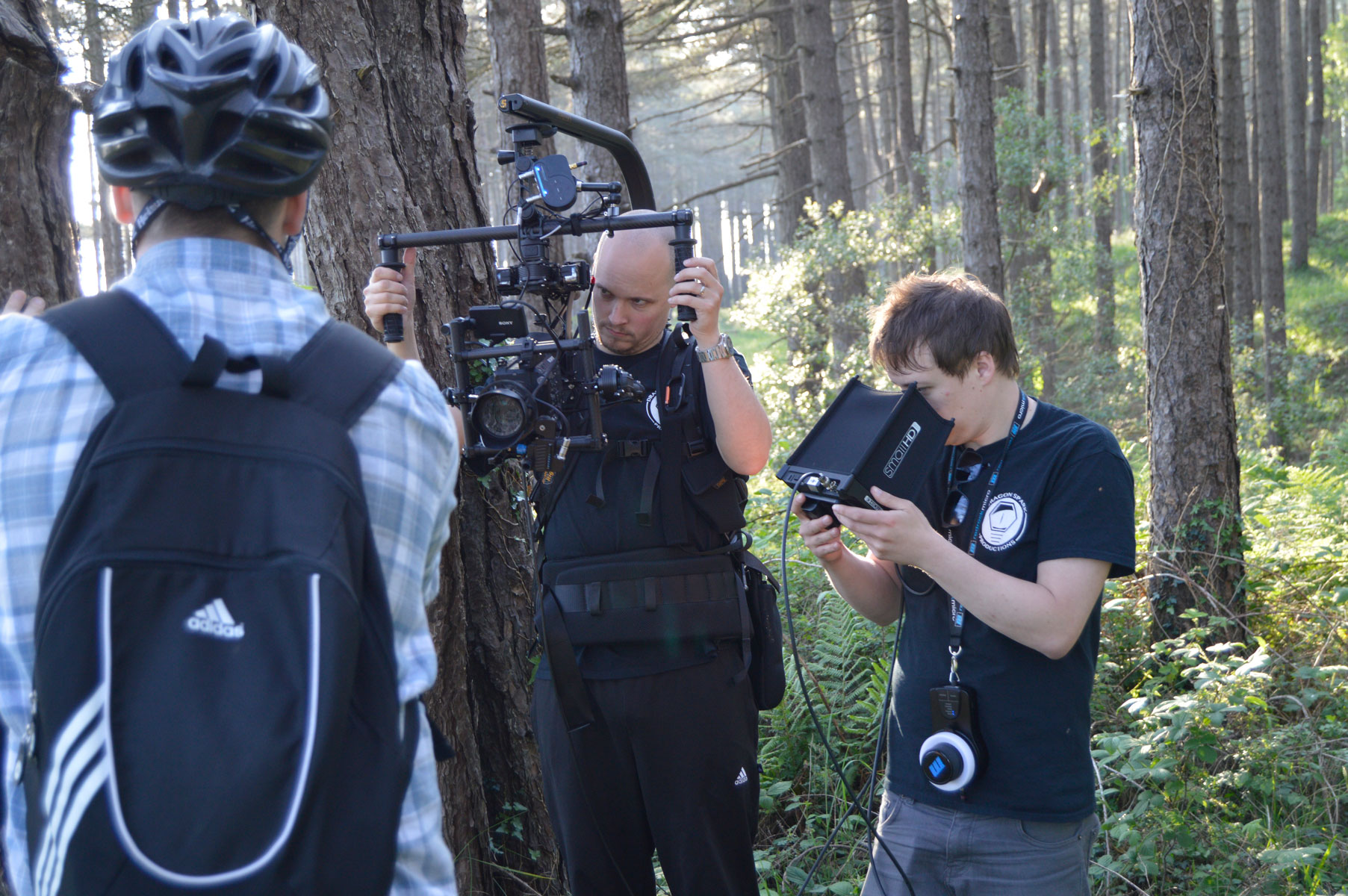 Filming a cyclist in the woods at Pembrey