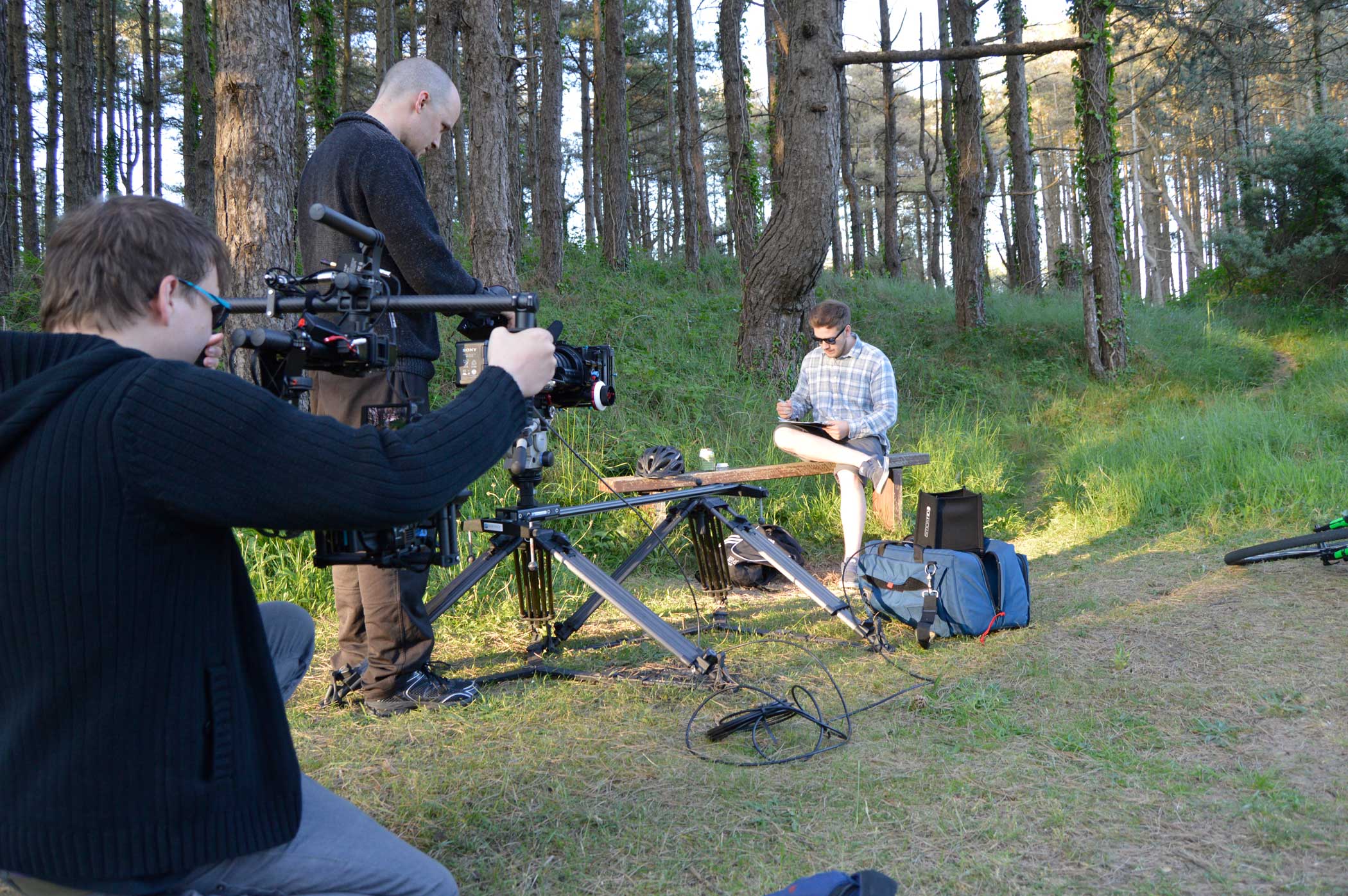 Filming a man drawing on a bench at Pembrey