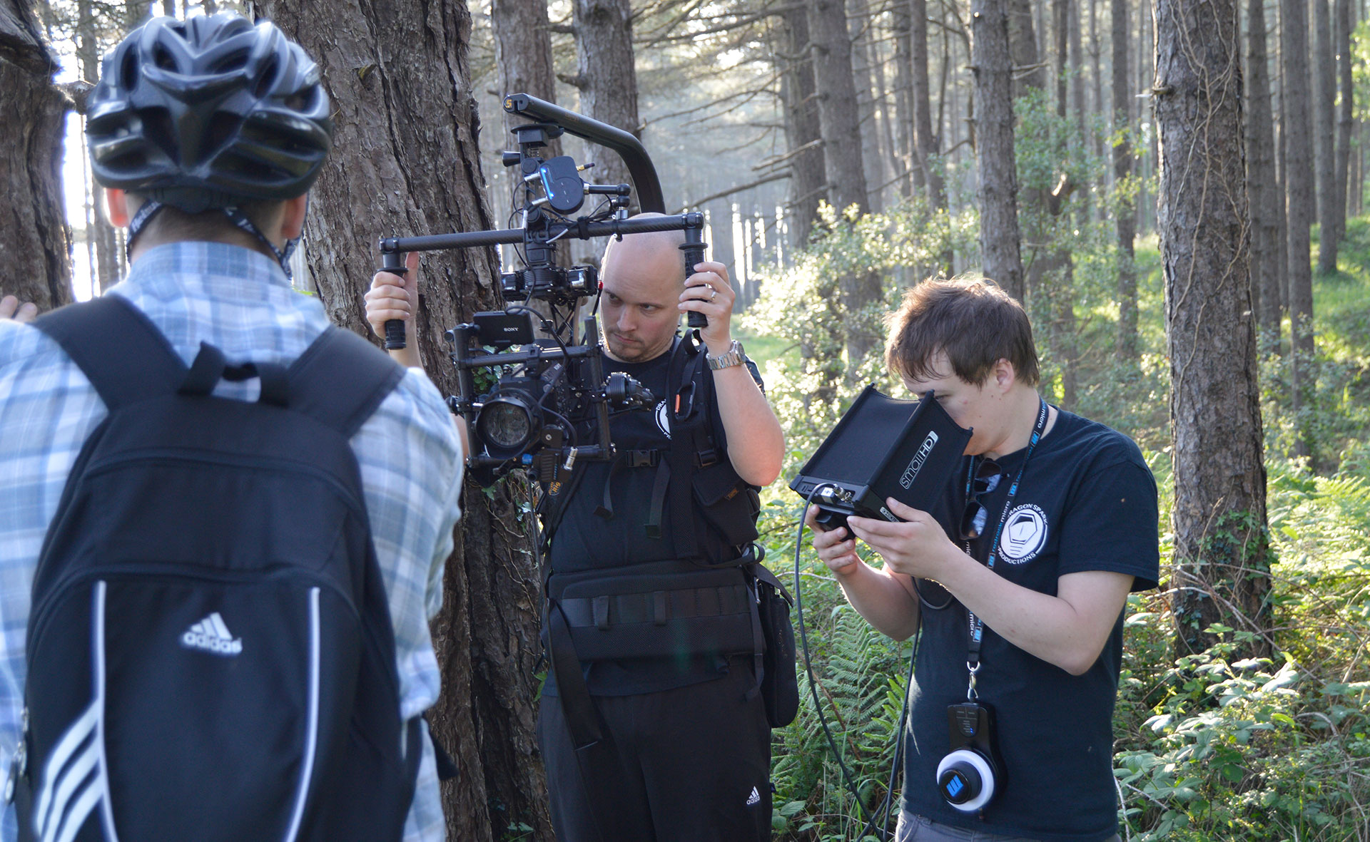 Filming a cyclist in the woods at Pembrey