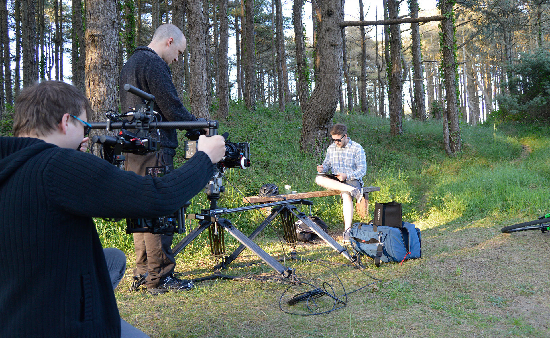 Filming a man drawing on a bench at Pembrey