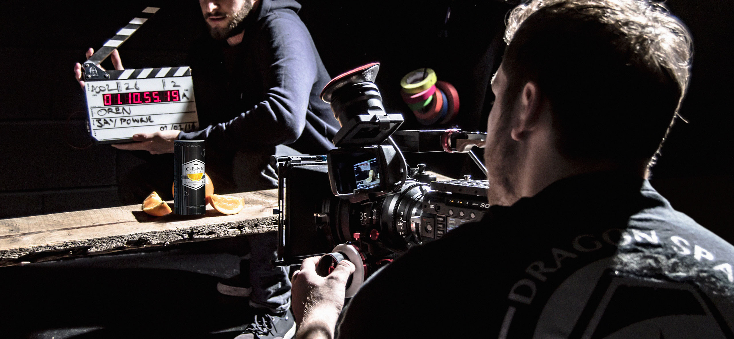 Camera filming energy drink with clapperboard